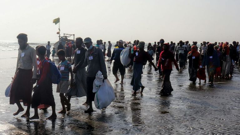 Rohingya people who were arrested at sea in December walk on a beach after being transported by Myanmar authorities to Thalchaung near Sittwe in Rakhine state on January 13, 2020. - 173 Rohingya Muslims fleeing Myanmar were arrested at sea in December by Myanmar&#39;s navy and were escorted back to Rakhine state on January 13, authorities said. (Photo by STR / AFP) (Photo by STR/AFP via Getty Images)
