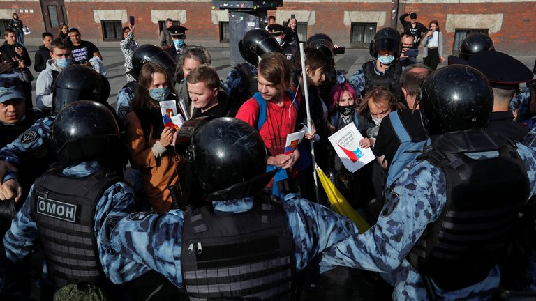 Officers block protesters at a rally in Saint Petersburg