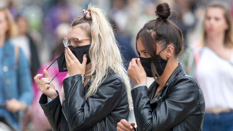 Shoppers wear protective face masks in Edinburgh&#39;s Princes Street.