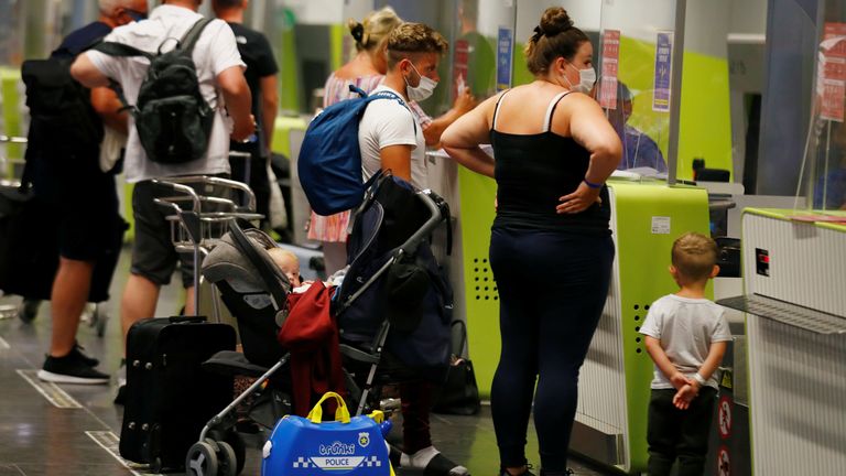 British tourists returning to UK check in their luggage at Gran Canaria Airport, Spain 