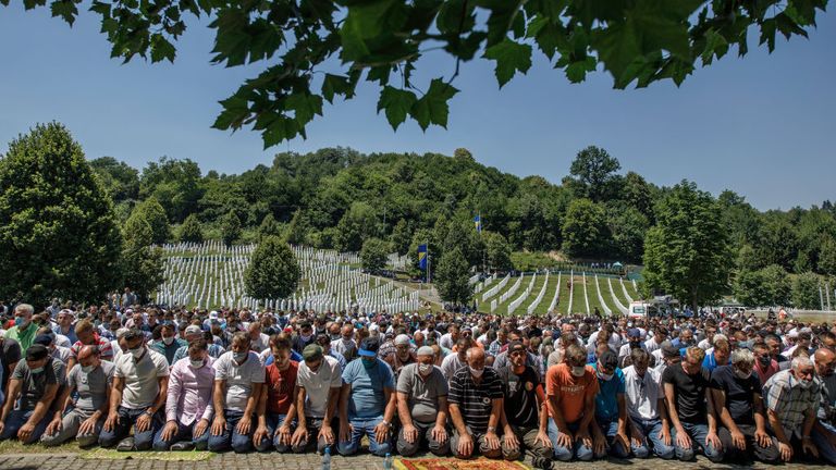 Bosnian Muslims pray during the mass funeral at the memorial and cemetery in Potocari near Srebrenica