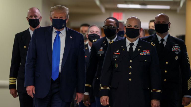 President Donald Trump wears a mask while visiting Walter Reed National Military Medical Center in Bethesda