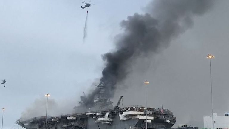 Chopper douses burning US naval vessel