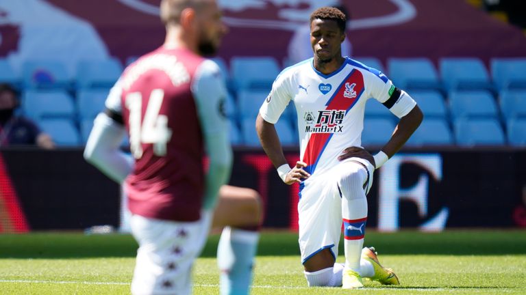 Crystal Palace&#39;s Wilfried Zaha takes a knee in in honour of Black Lives Matter movement during the Premier League match at Villa Park, Birmingham