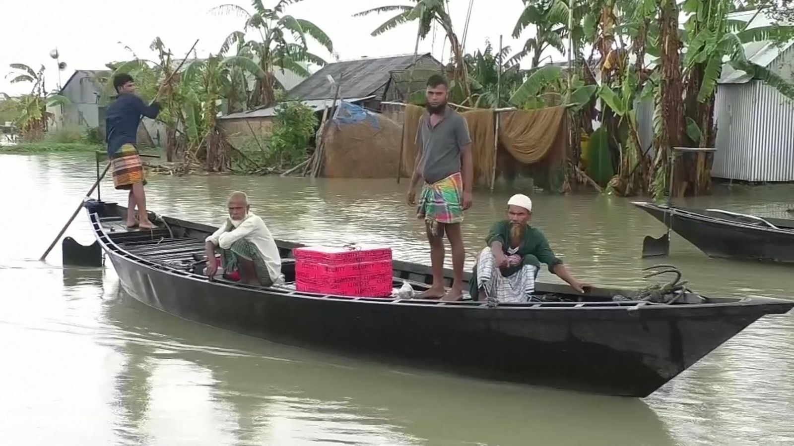 Family evacuate their home by boat in Bangladesh floods