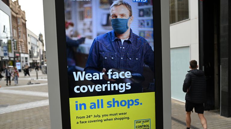 A sign calling for the wearing of face coverings in shops is displayed  in the city centre of Leeds, on July 23, 2020, as lockdown restrictions continue to be eased during the novel coronavirus COVID-19 pandemic. - The wearing of facemasks in shops in England will be compulsory from Friday, but full guidance is yet to be published. (Photo by Oli SCARFF / AFP) (Photo by OLI SCARFF/AFP via Getty Images)