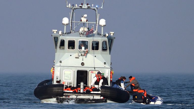 Border Force officers assist 20 Syrian migrants aboard HMC Hunter after they were stopped as they crossed The Channel in an inflatable dinghy headed in the direction of England.