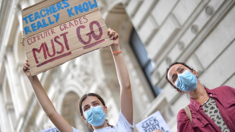 People take part in a protest outside Downing Street in London over the government's handling of A-level results. Thousands of pupils across England have expressed their disappointment at having their results downgraded after exams were cancelled due to coronavirus.