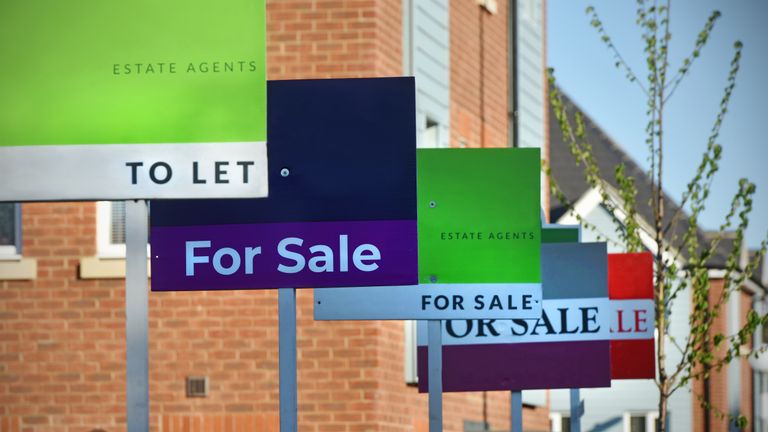 Generic For Sale and To Let Estate Agent (realtor) signs lined up outside a UK new build housing estate