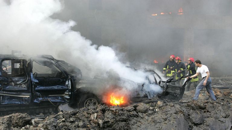 BEIRUT, LEBANON:  Firemen try to extinguish the fire engulfing one of the cars of the convoy of former Lebanese prime minister Rafiq Hariri at the scene of a massive explosion in Beirut 14 February 2005 Beirut. The huge explosion set ablaze cars and devastated buildings in a seafront area of the Lebanese capital on Monday, leaving smouldering bodies in the streets, local television pictures showed.   AFP PHOTO/JOSEPH BARRAK  (Photo credit should read JOSEPH BARRAK/AFP via Getty Images)