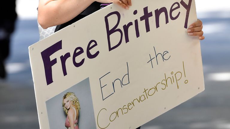 LOS ANGELES, CALIFORNIA - JULY 22: A supporter of Britney Spears gathers with others outside a courthouse in downtown for a #FreeBritney protest as a hearing regarding Spears' conservatorship is in session on July 22, 2020 in Los Angeles, California. Spears was placed in a conservatorship managed by her father, James Spears, and an attorney following her involuntary hospitalization for mental care in 2008. (Photo by Frazer Harrison/Getty Images)