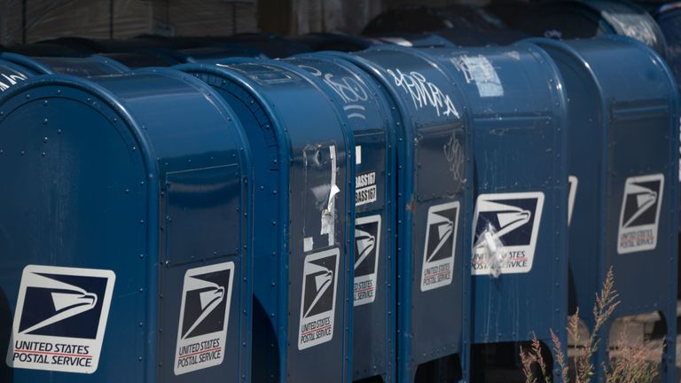 Mail boxes sit in the parking lot of a post office in the Borough of the Bronx on August 17, 2020 in New York. - The United States Postal Service is popularly known for delivering mail despite snow, rain or heat, but it faces a new foe in President Donald Trump. Ahead of the November 3 elections in which millions of voters are expected to cast ballots by mail due to the coronavirus, Trump has leveled an unprecedented attack at the USPS, opposing efforts to give the cash-strapped agency more money as part of a big new virus-related stimulus package, even as changes there have caused delays in mail delivery. (Photo by Bryan R. Smith / AFP) (Photo by BRYAN R. SMITH/AFP via Getty Images)