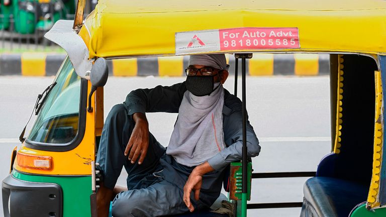 An auto rickshaw driver wearing a facemask as a preventive measure against the spread of the Covid-19 coronavirus, waits for passengers in New Delhi on August 30, 2020. - India on August 30 set a coronavirus record when it reported 78,761 new infections in 24 hours -- the world's highest single-day rise -- even as it continued to open up the economy. (Photo by Sajjad  HUSSAIN / AFP) (Photo by SAJJAD  HUSSAIN/AFP via Getty Images)