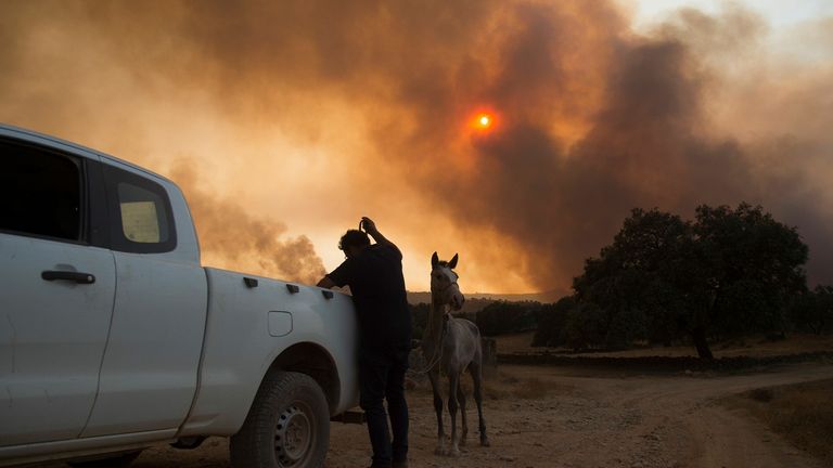 Smoke billows from a wildfire over El Buitron in Huelva, Andalusia