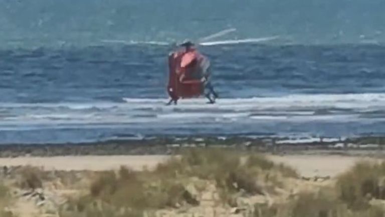 Caption: Emergency services at Barmouth beach in Gwynedd, north Wales, on August 2, 2020