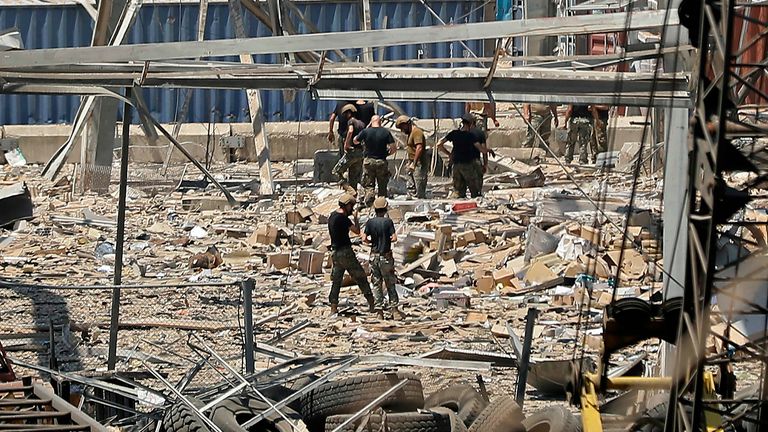 Rescuers and civil defence search through the debris at Beirut port