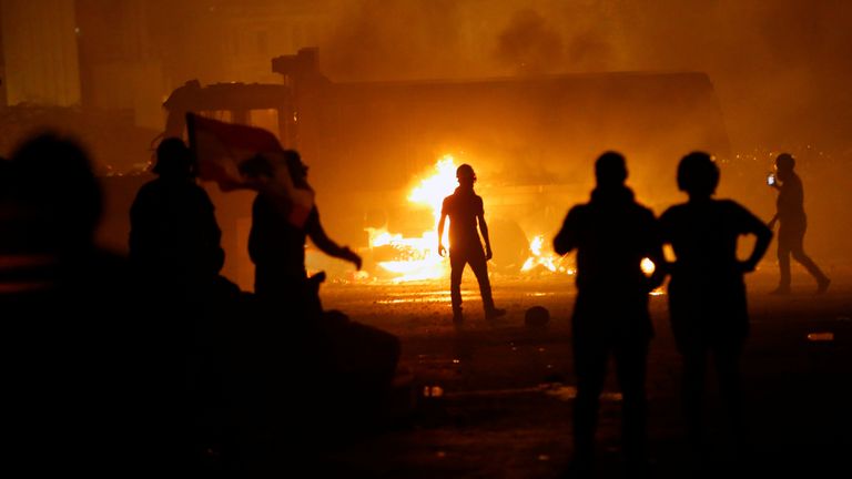 A truck is set on fire during protests over a devastating blast in Beirut 