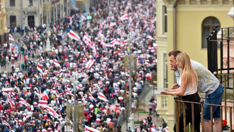 A couple look down at the demonstration