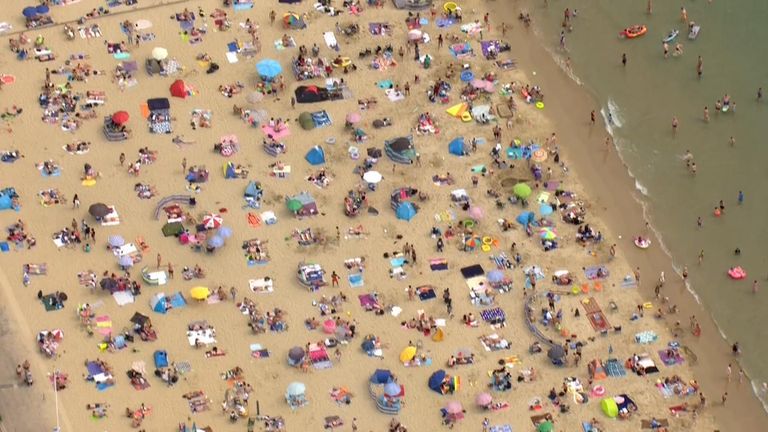 A birds-eye view of  people enjoying a day out at the beach in Bournemouth