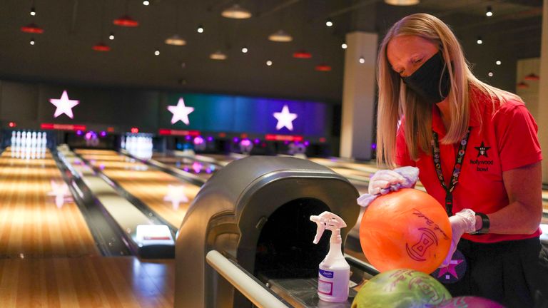A member of Staff at Hollywood Bowl in Thurrock, Essex, cleans the bowling balls. One of several potential workplace safety measures being put in place whilst waiting for future UK government guidelines regarding the reopening of leisure businesses