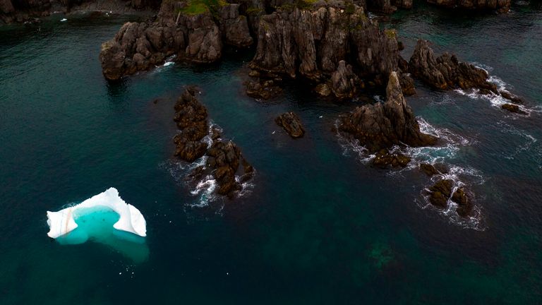 An iceberg floats near Bonavista in the early morning of July 7, 2019 in Newfoundland, Canada. - Iceberg water, considered pure, is now marketing for a unique sector of high-end products. "We are trying to target the niche market for healthy foods and products," says former fisherman Edward Kean, an iceberg hunter. For 20 years, he has been cruising the North Atlantic aboard his fishing boat to retrieve chunks of ice to melt and sell the water to local traders. Customers include manufacturers of