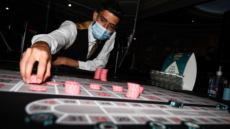 Staff clean chips with antibacterial wipes at The Rialto casino in central London as they prepare for reopening at midnight as coronavirus lockdown measures continue to be eased in England. PA Photo. Picture date: Friday August 14, 2020. See PA story POLITICS Coronavirus. Photo credit should read: Kirsty O&#39;Connor/PA Wire