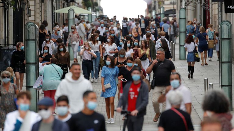 People wearing protective masks walk in a street in Nantes as France reinforces mask-wearing as part of efforts to curb a resurgence of the coronavirus disease (COVID-19) across the country, France, August 24, 2020. REUTERS/Stephane Mahe