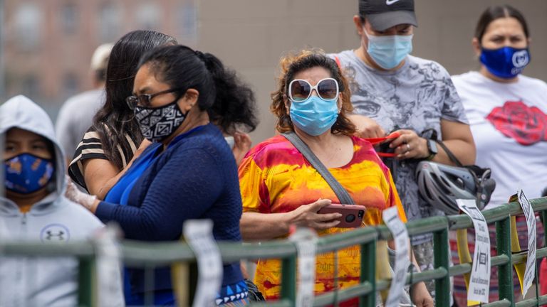 Customers wait in line to shop for food at a Food 4 Less grocery store, during the outbreak of the coronavirus disease (COVID-19), in Los Angeles