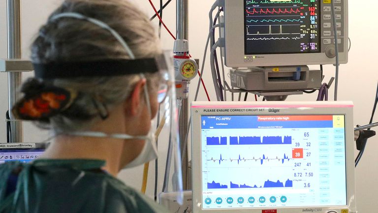 An ICU nurse monitors a ventilator at Frimley Park Hospital in Surrey