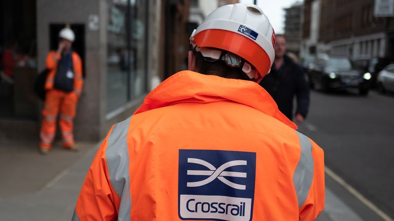 Members of the construction team stand outside the entrance hall of Farringdon Crossrail station