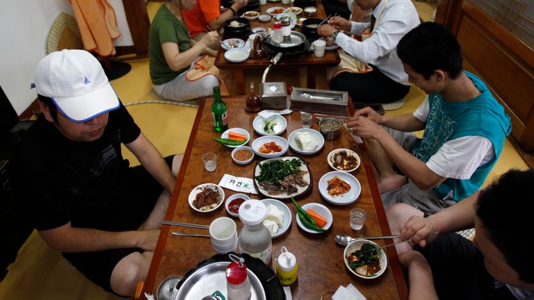 People eat dog meat at a restaurant in South Korea
