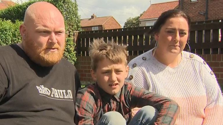 Eli Harrison, pictured with his parents Ian and Kayleigh, jumped in the sea to save a toddler 