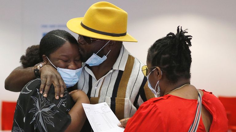 Parents and a student react after checking the GCSE results at Ark Academy, amid the spread of the coronavirus disease (COVID-19), in London, Britain August 20, 2020. REUTERS/Peter Nicholls