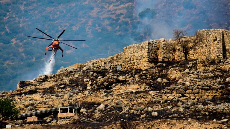 Firefighting helicopters were deployed to drop water over the archaeological site in Greece