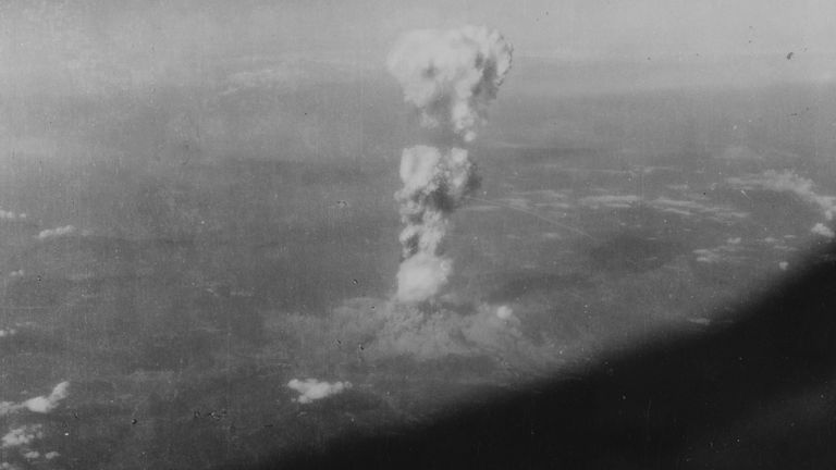 The distinctive &#39;mushroom cloud&#39; from the explosion begins to form above Hiroshima