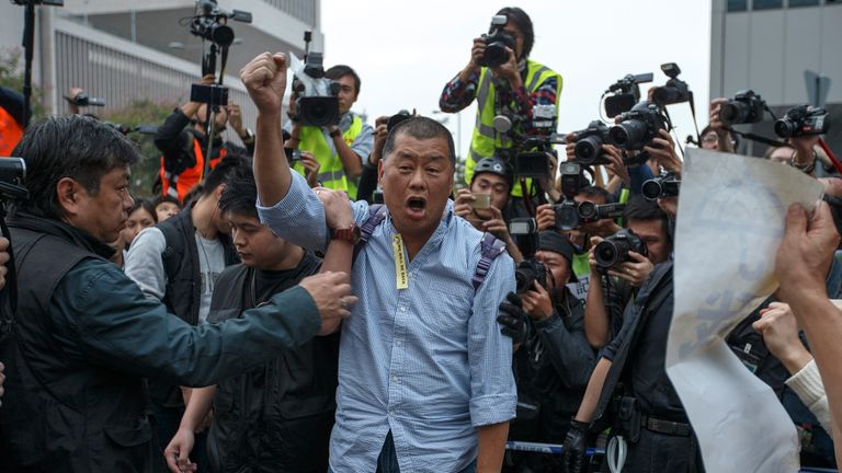 Tycoon and Apple Daily Newspaper owner Jimmy Lai shouts slogan before he is taken away by police officer at an area previously blocked by pro-democracy supporters, outside the government headquarters in Hong Kong, December 11, 2014. Hong Kong authorities started on Thursday clearing the main pro-democracy protest site that has choked roads into the city&#39;s most economically and politically important district for more than two months as part of a campaign to demand free elections.