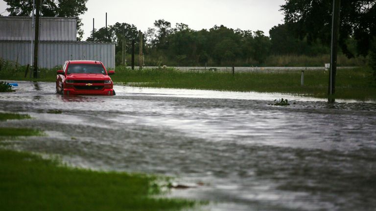 A car near Vermilion Bay, in southern Louisiana, partially submerged in waters brought by Hurricane Laura