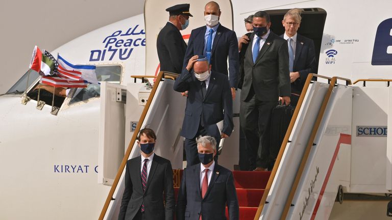 US presidential adviser Jared Kushner (C-L) and US national security adviser Robert O'Brien (C-R) disembark from the flight