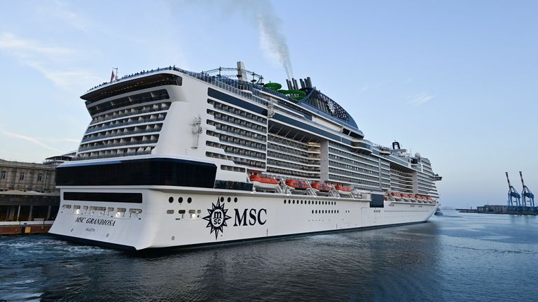 A picture taken in the northern Italian port of Genoa on August 16, 2020 shows the MSC Grandiosa cruise liner leaving port after six-and-half months of inactivity due to the novel coronavirus, COVID-19, pandemic. - The first major cruise ship to set sail in the Mediterranean was poised to depart from Genoa as Italy&#39;s struggling travel industry hopes to regain ground after a bruising coronavirus hiatus, representing a high-stakes test for the global sector in the key Mediterranean market and beyo
