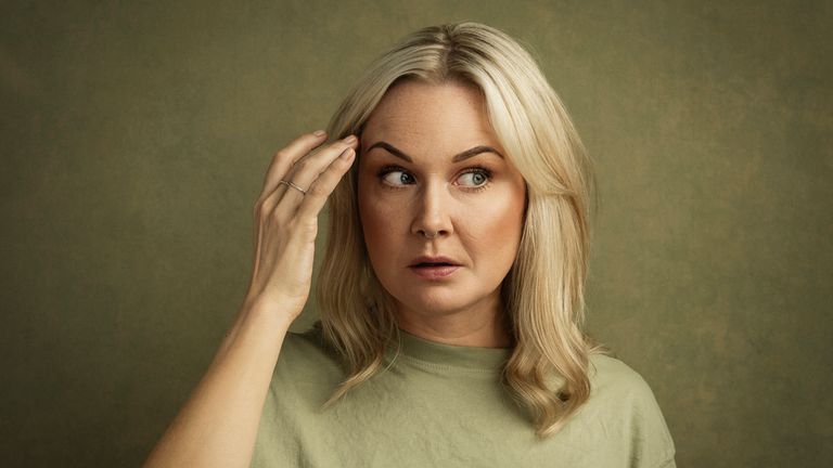 Woman with sideways glance wondering whats happening questioning face Photo taken indoors in studio of mid adult woman