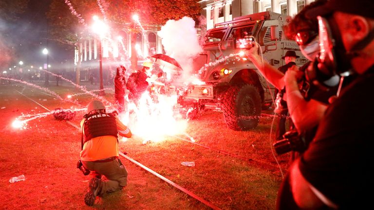 Flares go off in front of a Kenosha Country Sheriff Vehicle as demonstrators take part in a protest following the police shooting of Jacob Blake, a Black man, in Kenosha, Wisconsin, U.S. August 25, 2020. REUTERS/Brendan McDermid TPX IMAGES OF THE DAY