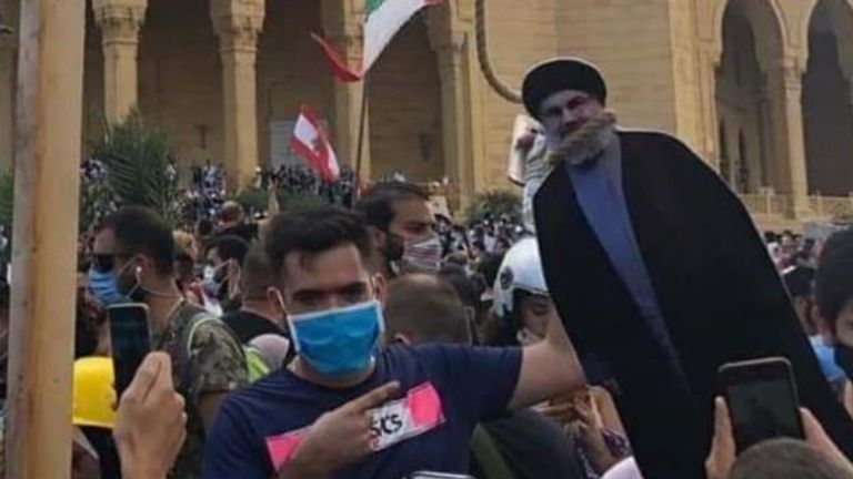 A cardboard cutout of Hezbollah leader Hassan Nasrallah is placed in a noose