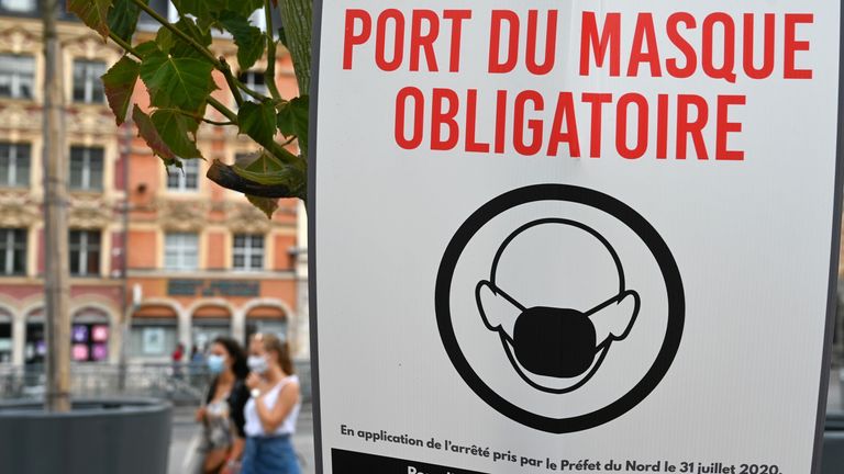 A sign reading &#39;wearing protective mask is mandatory&#39; on a street in Lille, one of France&#39;s cities to introduce the measure