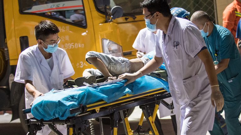 Medical workers carry an injured person out of the rubble of a collapsed restaurant in Linfen, in China&#39;s northern Shanxi province