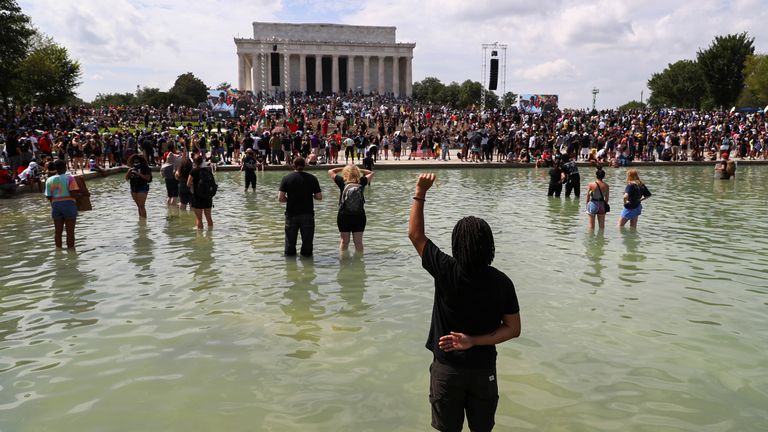 Demonstrators stand in the waters of the Lincoln Memorial reflecting pool as they listen to the families of people killed in interactions with police during the "Get Your Knee Off Our Necks" Commitment March on Washington in support of racial justice in Washington, U.S., August 28, 2020. REUTERS/Tom Brenner