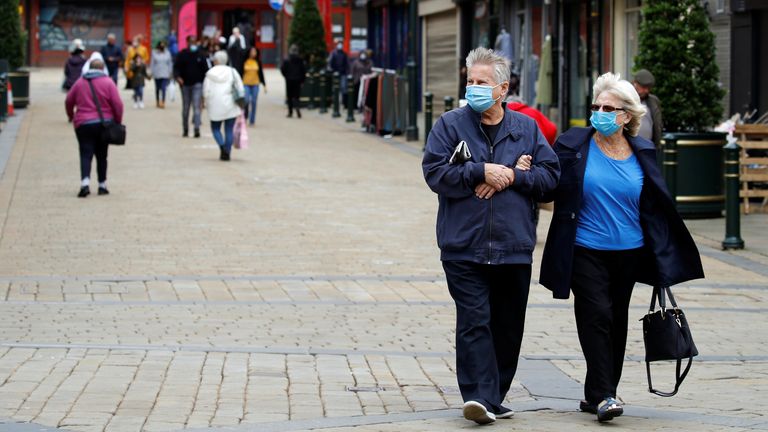 People wear protective face masks as they walk in Oldham, as the town faces local restrictions in an effort to avoid a local lockdown being forced upon the area amid the coronavirus disease (COVID-19) outbreak, Britain July 29, 2020. REUTERS/Phil Noble