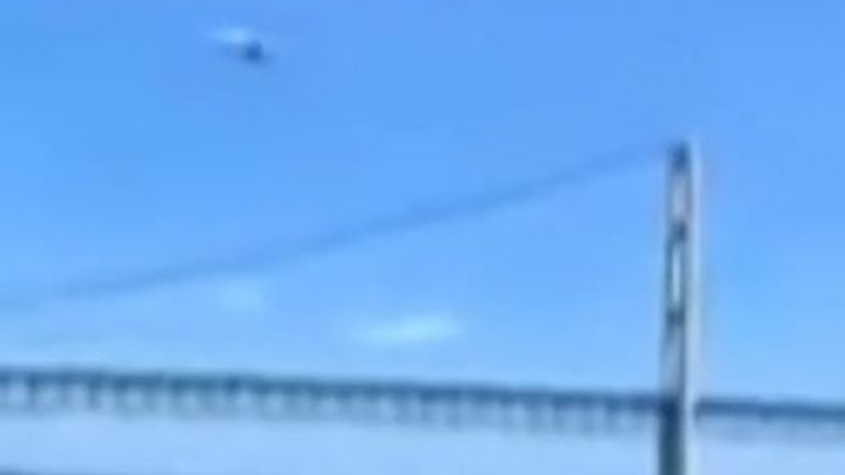 Small plane is filmed flying under a bridge in Michigan