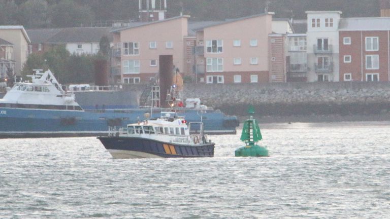 This is the description: Southampton Harbour Master launch inspecting a buoy off Hythe, Hampshire, after twelve people were taken to hospital when a rigid inflatable boat collided with a buoy in a Hampshire marina at 10.10am on Saturday. A 15-year-old girl was pronounced dead in hospital.