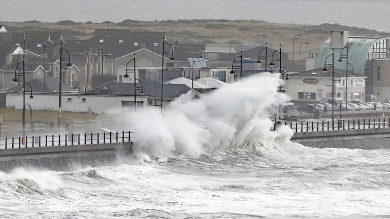 Waves crashing into the seafront at Tramore in County Waterford, on the southeast coast of Ireland.