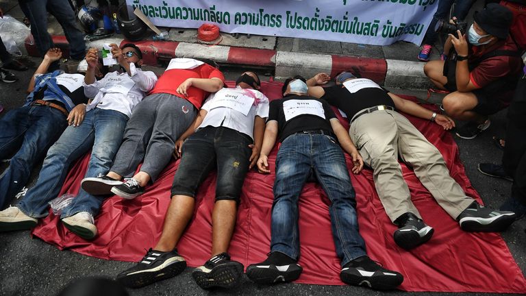 Anti-government protesters take part in a reenactment of the 2010 deaths of "Red Shirt" activists during a military crackdown, at a pro-democracy protest in Bangkok on August 16, 2020. - Protesters gathered for a rally in Bangkok on August 16 against the government as tensions rose in the kingdom after the arrest of three activists leading the pro-democracy movement. (Photo by Lillian SUWANRUMPHA / AFP) (Photo by LILLIAN SUWANRUMPHA/AFP via Getty Images)
